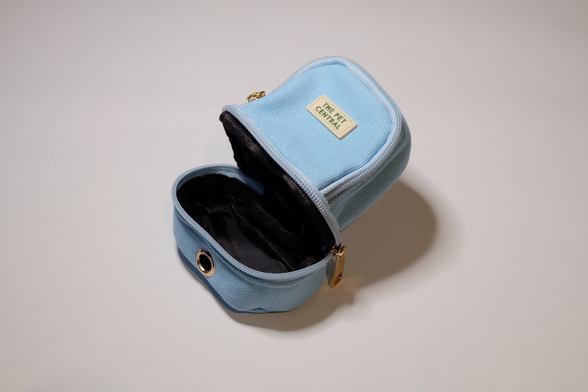 The Pet Central - The Paw Pack in Blue with an Open Poop Bag Holder Compartment