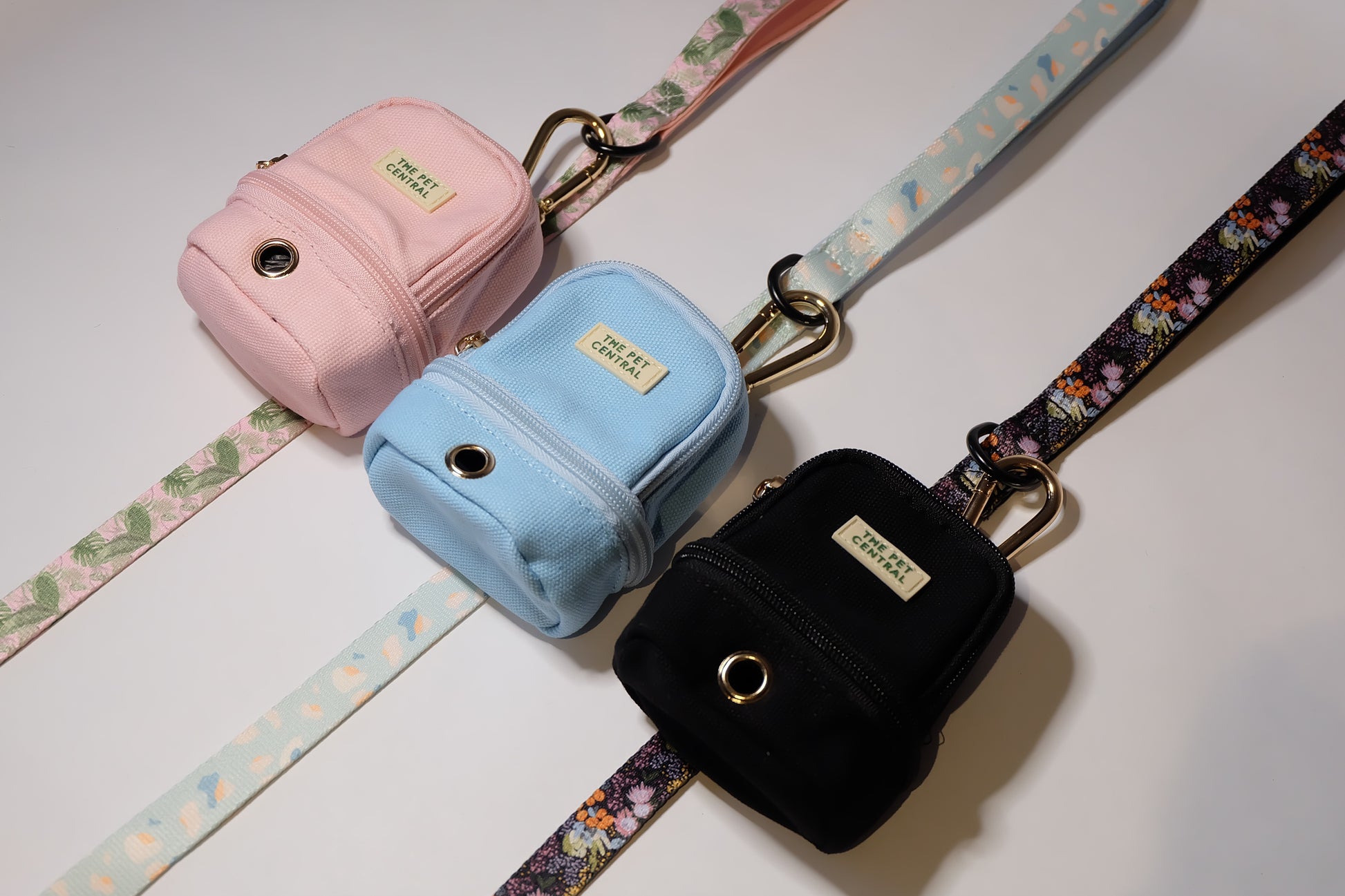 The Pet Central - The Paw Pack in Pink Attached to Tropical Bloom Lead, Blue Attached to Blue Cheetah Lead, and Black Attached to Native Nighttime Lead