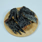 Dehydrated crocodile feet for dogs displayed on a round wooden plate – single-ingredient pet treat