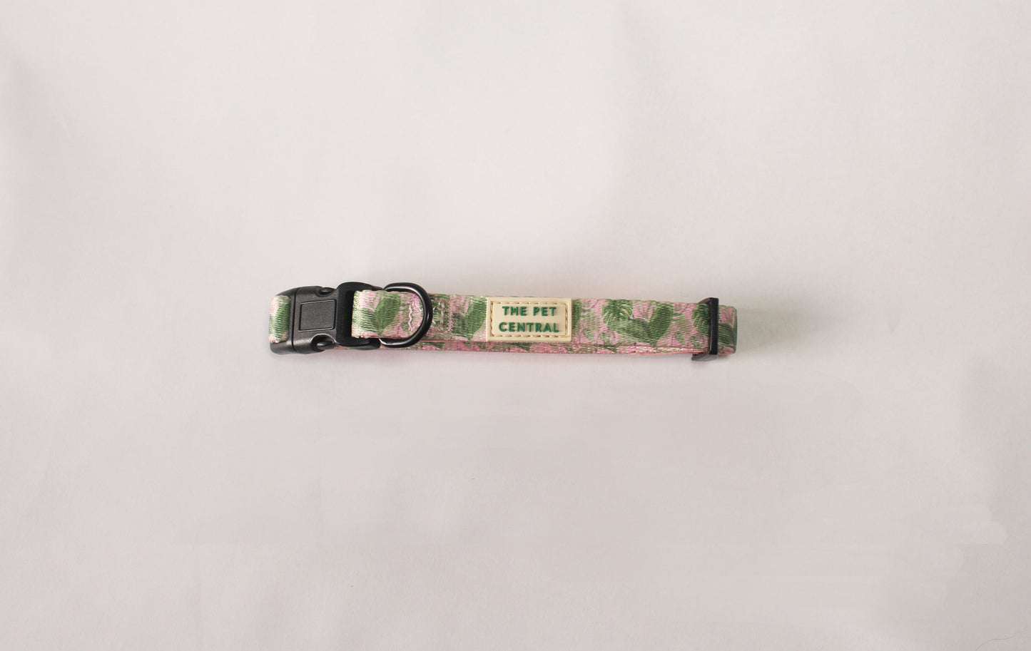 The Pet Central Tropical Bloom dog collar with black plastic clip and black metal hardware.